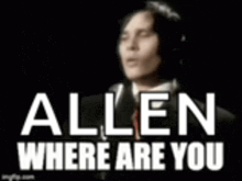 a man in a suit and tie is standing in front of a black background with the words allen where are you written on it .