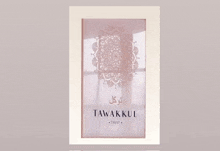 a picture frame with a picture of a mandala on it that says tawakul trust