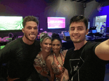 a group of people are posing for a picture in front of a screen that says rebecca ruby