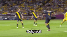 a group of soccer players are on a field with the word colpisci written on the bottom