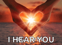 a person making a heart shape with their hands with the words " i hear you " below them