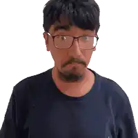 a man with glasses and a beard looks at the camera