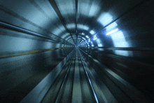 a train is going through a tunnel with a lot of tracks