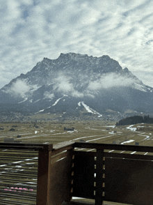 a view of a mountain from a balcony with snow on the slopes