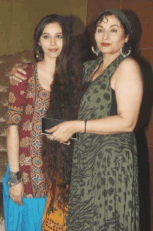 a woman in a leopard print dress stands next to another woman with long hair