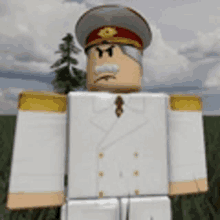 a toy soldier is standing in a field wearing a white uniform and a red hat .