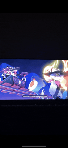 a group of cartoon characters are riding a roller coaster on a screen .