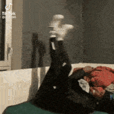 a person is laying on their stomach with their feet up in the air .