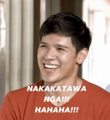 a man in a red shirt is laughing with the words nakatawa nga !!! hahaha !!! below him