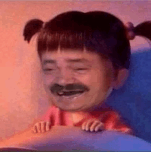 a man with a mustache and pigtails is sitting on a bed .