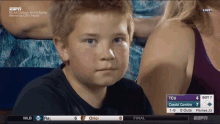 a young boy is watching a baseball game between tcu and coastal carolina