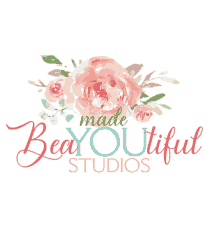 a logo for bea youtiful studios with flowers and green leaves