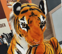 a stuffed tiger with a star in its eyes stands in front of a sign that says order