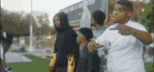 a group of young men are standing next to each other in front of a sign that says ' chicago white sox ' on it