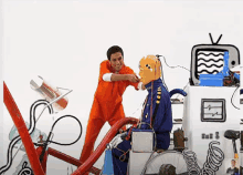 a man in an orange jumpsuit is standing next to a man in a blue jumpsuit