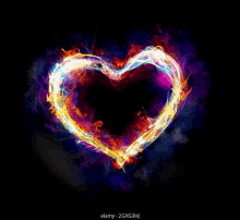 a colorful heart made of fire and smoke on a black background .