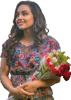 a woman in a colorful dress holding a bouquet of flowers