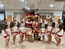 a group of people are posing for a picture in front of a sign that says ' i love you '