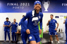 a group of soccer players are standing in a locker room in front of a sign that says final 2021 porto