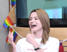 a woman wearing a white t-shirt that says long love on it