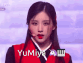 a woman in a red jacket with the name yumiya written on her face