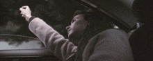 a woman in a car with her eyes closed