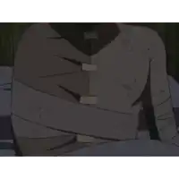 a man with a bandage on his face is screaming in a dark room .