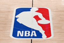 a close up of the nba logo on a wooden court .