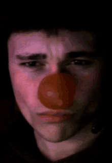 a man wearing a clown nose and a headset