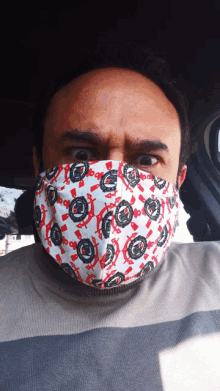 a man wearing a face mask with a pattern of circles