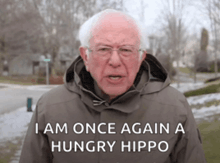 a man in a hooded jacket says " i am once again a hungry hippo "
