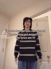 a young man wearing a striped shirt is standing in front of a door with a caption that reads beat so bumpin