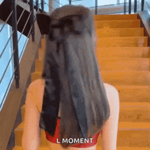 a woman with a black bow in her hair is walking down stairs .