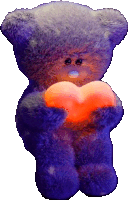 a teddy bear is holding an orange heart