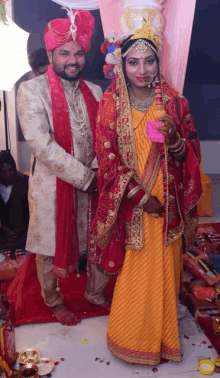 a bride and groom posing for a picture in their wedding outfits