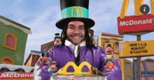 a man in a top hat is holding a happy meal box in front of a mcdonald 's