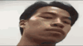 a close up of a man 's face making a funny face .