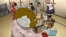 a group of people are gathered around a table with a carton of milk in the middle