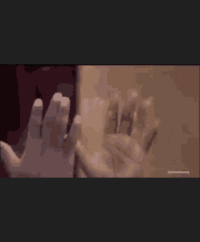 a close up of a person 's hands reaching out towards each other