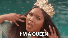 a woman wearing a crown is screaming and says `` i 'm a queen '' .