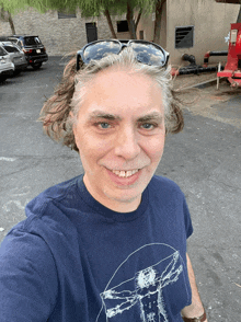 a man wearing sunglasses and a t-shirt with a drawing of a mushroom on it