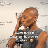 a woman is talking into a microphone and says pov : me trying to remember the answers in the exam .