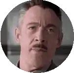 a man with a mustache looks at the camera in a circle