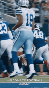 a football player is jumping in the air while playing a game of football on a field .