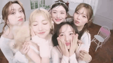 a group of young women are posing for a picture together and making funny faces .