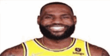 a basketball player with a beard is smiling for the camera while wearing a yellow jersey .