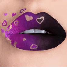 a close up of a woman 's lips with purple and black lipstick and hearts painted on them