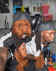 a man with dreadlocks is holding a dog with a dog face