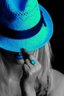 a woman is wearing a blue hat and a blue ring .