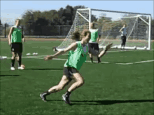 a group of women are playing soccer on a field and one of them is jumping in the air .